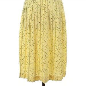 Yellow midi accordion skirt with navy sprinkles.